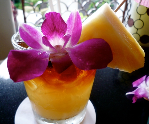 A mai tai cocktail, garnished with a Hawaiian orchid